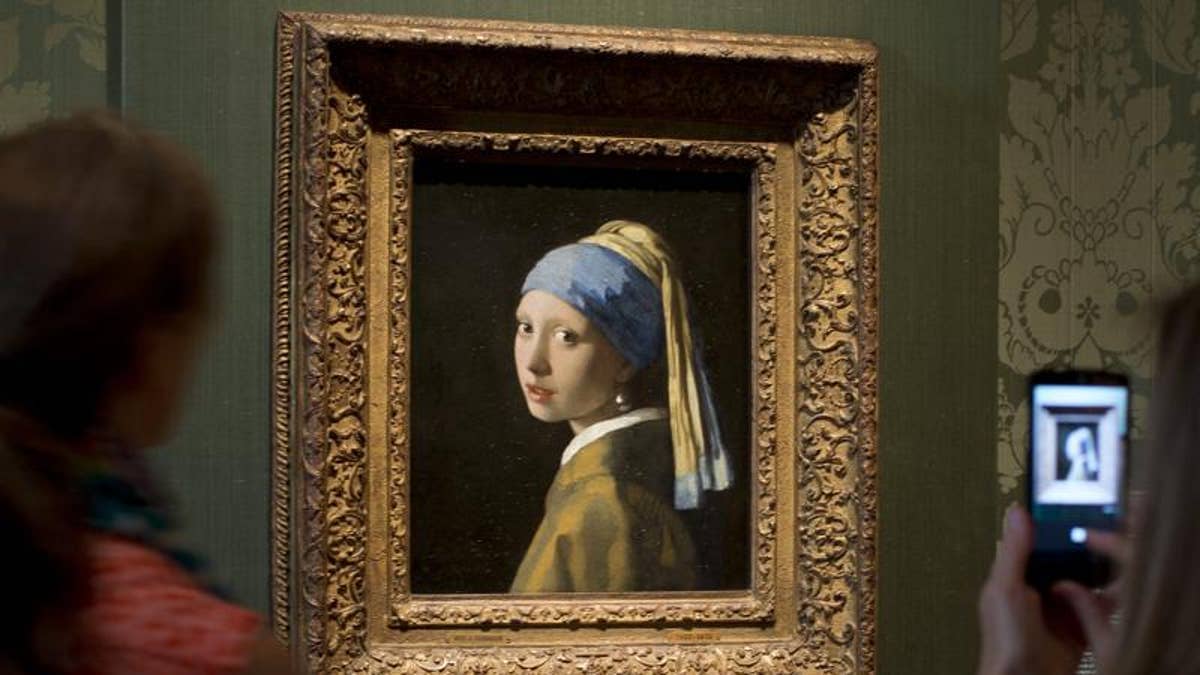 Climate activist glues his head to 'Girl with a Pearl Earring' painting in The Hague